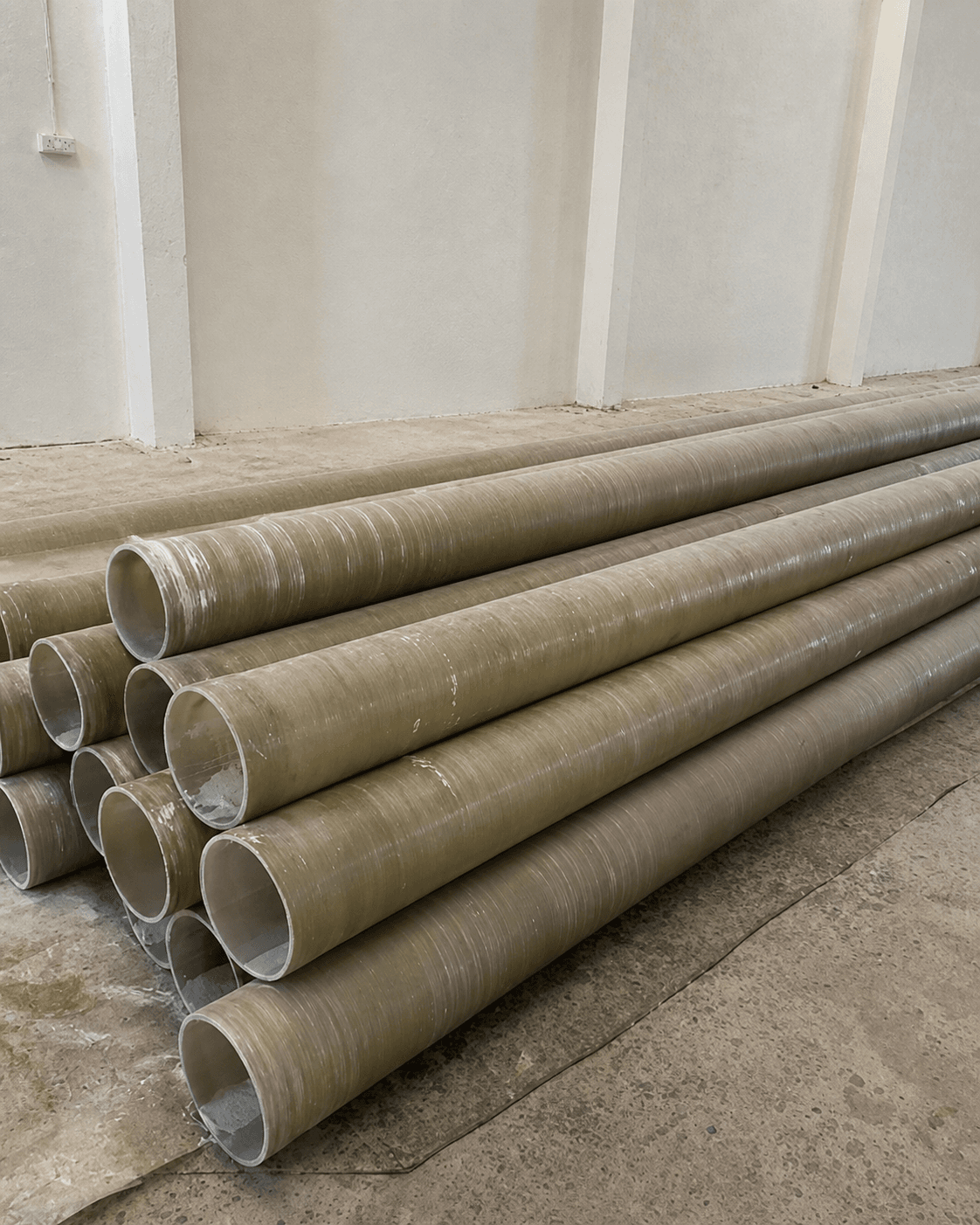 Stacked corrosion-resistant composite pipes in AMPAR's fabrication facility