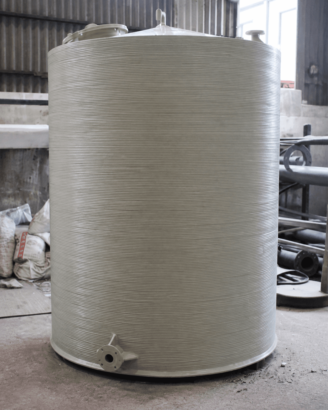 Dual-laminate storage tank with a thermoplastic liner and FRP structural reinforcement